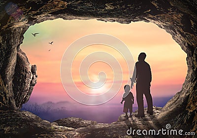 Father and son holding hand in hand on tombstone sunset Stock Photo