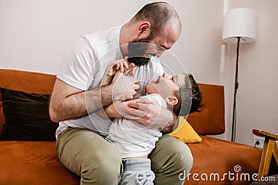 Father and son play together at home Stock Photo