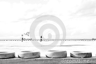 Father and son playing kite in a pier Stock Photo