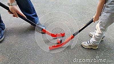 Father and son playing Outdoor hockey Stock Photo