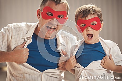 Father and son playing superhero outdoors at the day time. Stock Photo