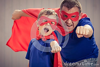 Father and son playing superhero outdoors at the day time. Stock Photo