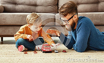 Father and son playing the toys cars at home Stock Photo