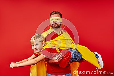 Father and son pretend being real superheroes, want to fly Stock Photo