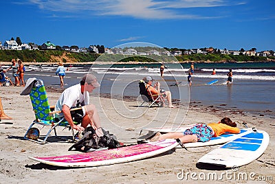 A father and son relax on the beach on a sunny day Editorial Stock Photo