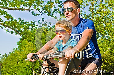 Father and son riding a bicycle Stock Photo