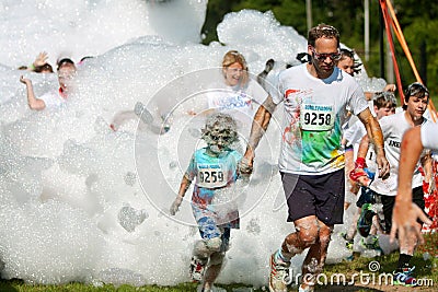 Father And Son Run Through Foamy Bubbles At Bubble Palooza Editorial Stock Photo
