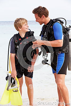 Father And Son With Scuba Diving Equipment On Beach Holiday Stock Photo