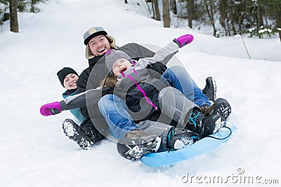 Father and son sledding at winter time Stock Photo