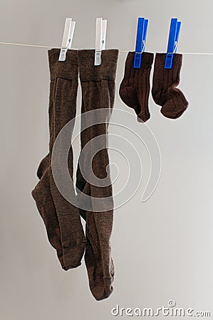 Father and son socks drying on clothesline Stock Photo