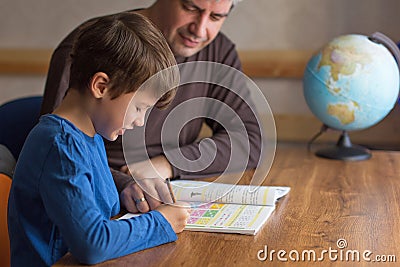 Father and son solving mathematics homework togehter Stock Photo