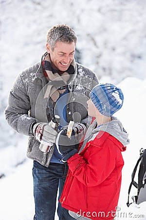 Father And Son Stopping For Hot Drink And Snack Stock Photo