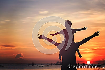 Father and son on sunset beach Stock Photo