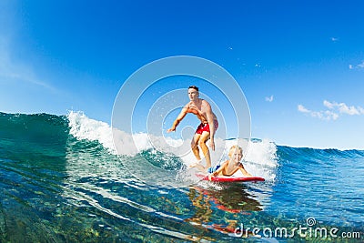 Father and Son Surfing, Riding Wave Together Stock Photo