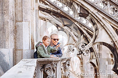 Father with son tourists are on the roof of Milan Cathedral Stock Photo
