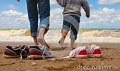 Father and son walk at the seaside Stock Photo