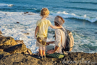 Father and son are walking along the cosmic Bali beach.. Portrait travel tourists - dad with kids. Positive human Stock Photo