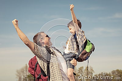 Father and son walking on the road at the day time. Stock Photo