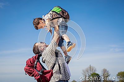 Father and son walking on the road at the day time. Stock Photo