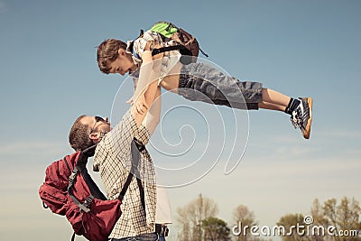 Father and son walking on the road at the day time. Stock Photo