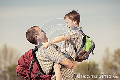 Father and son walking on the road at the day time. Stock Photo