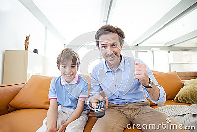 Father and son watching tv Stock Photo