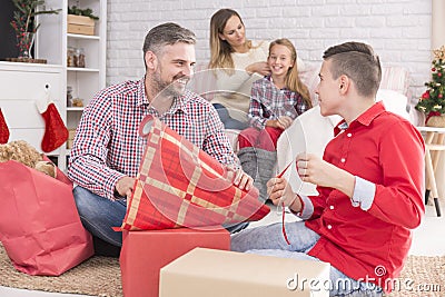 Father and son wrapping gifts Stock Photo