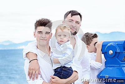 Father and sons at sea. Family on viewing platform near the Coin Stock Photo