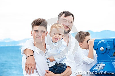 Father and sons at sea. Family on viewing platform near the Coin Stock Photo