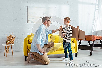 Father stand on knee near happy Stock Photo