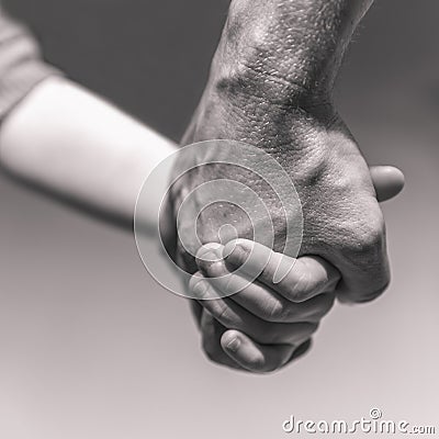 A father taking his child gently by the hand, giving her a warm, safe, secure, protected and comforting feeling Stock Photo