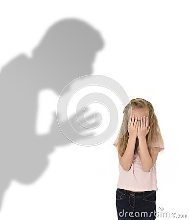 Father or teacher shadow screaming angry reproving young sweet little schoolgirl or daughter Stock Photo