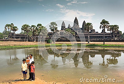 Father with three kids standing past historical landscape of Angkor What temple, 12th century Khmer landmark Editorial Stock Photo