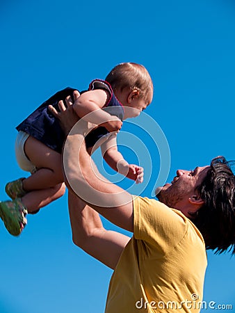Father throws his daughter up, playing Stock Photo