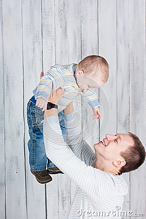 Father throws up in the air his little son. Stock Photo