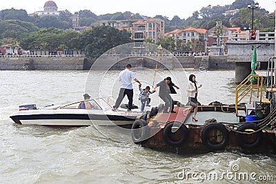 Father took his son's hand from the Speedboat to shore Editorial Stock Photo