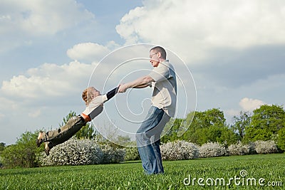 Father twirling his little son Stock Photo