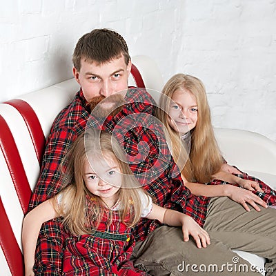 Father with two daughters cuddling Stock Photo
