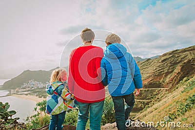 Father and two kids travel hiking looking at nature Stock Photo