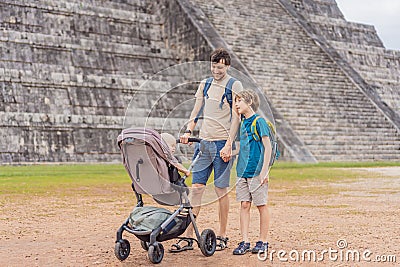 Father and two sons tourists observing the old pyramid and temple of the castle of the Mayan architecture known as Stock Photo