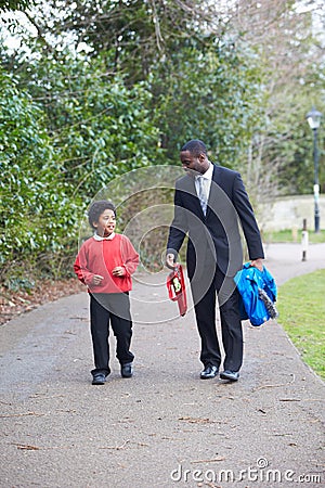 Father Walking Son To School Along Path Stock Photo