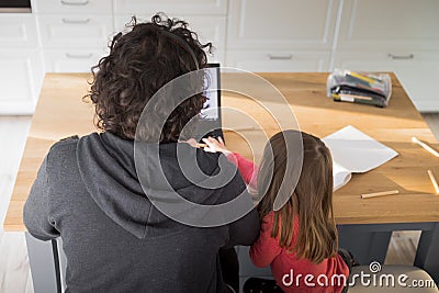 Father working from home with little daughter annoying him during covid-19 lockdown. Aerial, top view Stock Photo