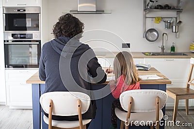 Father working from home with little daughter during covid-19 lockdown. Back view Stock Photo