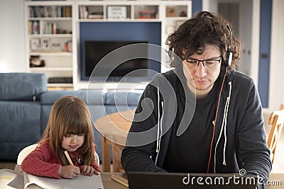 Father working from home with little daughter during covid-19 lockdown Stock Photo