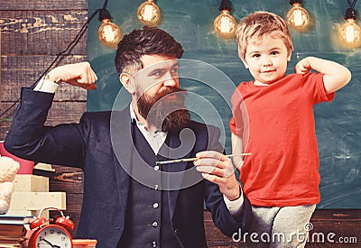 Fatherhood concept. Talented artist spend time with son. Teacher with beard, father and little son having fun in Stock Photo