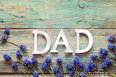 Fathers Day message with blue flowers on old wooden background. Stock Photo