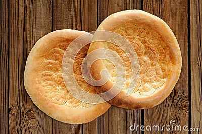 Fatir, uzbek flatbread on old wooden background top view Stock Photo