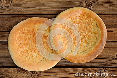 Fatir, uzbek flatbread on old wooden background top view Stock Photo