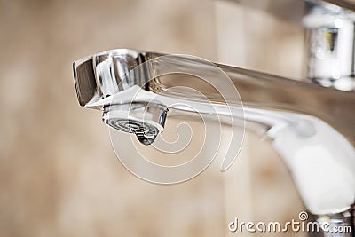 Faucet with dripping water. Tap closeup with dripping water-drop. Water leaking, saving concept Stock Photo