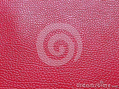 Faux red leather. Separate grooves and elevations on the surface of a bag or shoe. Reflection of the light. Fashion accessory made Stock Photo